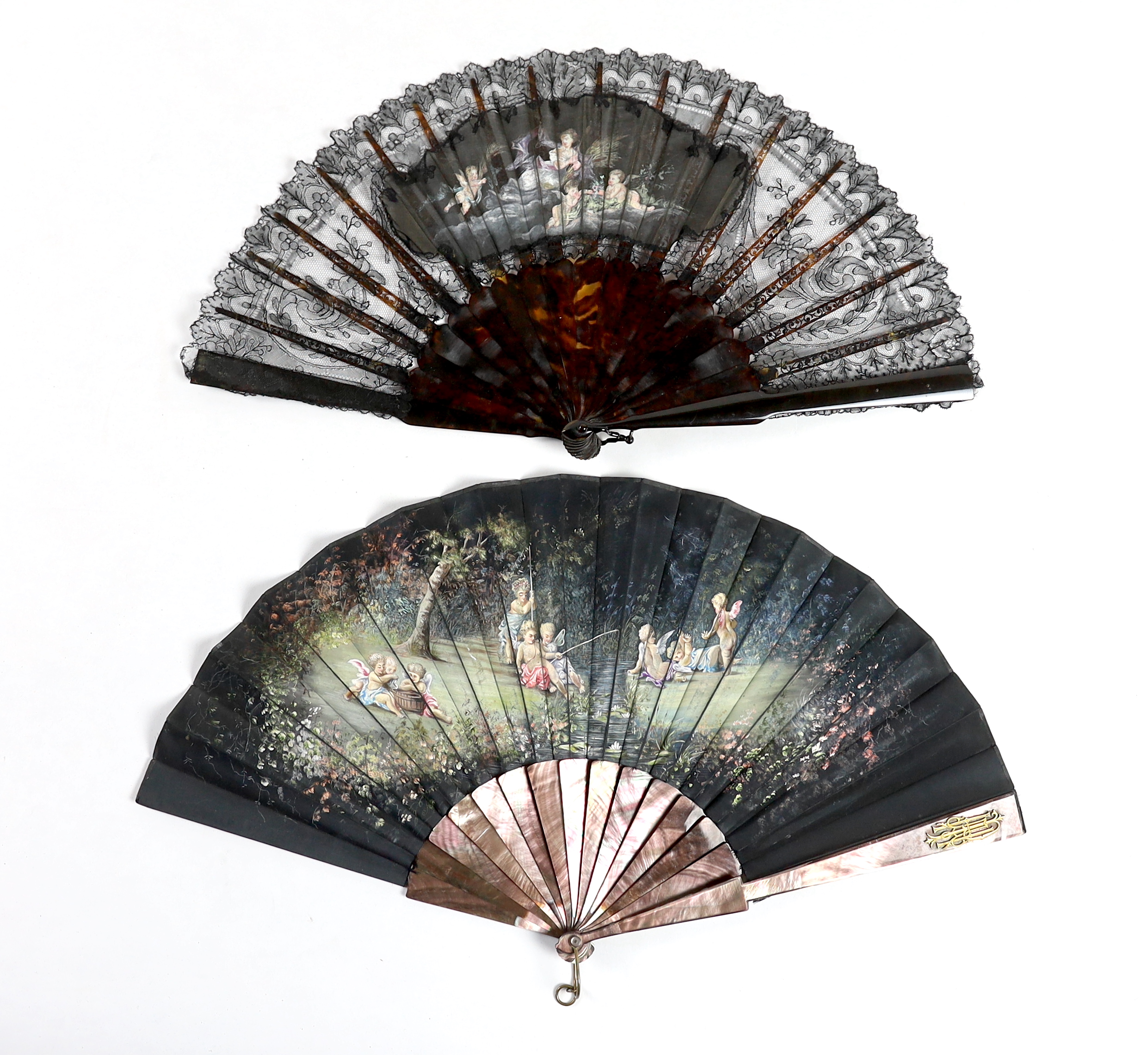 A late Victorian Chantilly black lace and tortoiseshell fan with a central painted cartouche and a mother of pearl and hand painted fairy and cherub fan, indistinctly signed